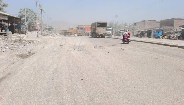 A treacherous web of stones blankets the road, with the threat of an accident looming at every moment.