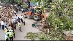 Administration's bulldozer razes illegal shrine built on PWD road in Loni